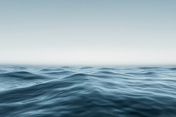 Fototapeta premium Gentle waves roll across the ocean surface as early morning light casts a serene glow, creating a peaceful and tranquil atmosphere