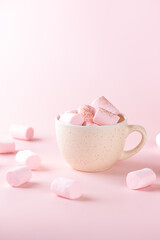 Chocolate drink with marshmallows in a mug on a pink background. Vegan, sugar and lactose free. Vertical orientation.