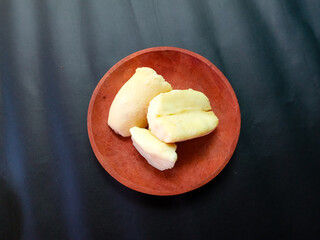 sliced fermented cassava on a plate. tape or traditional Indonesian food made from fermented...