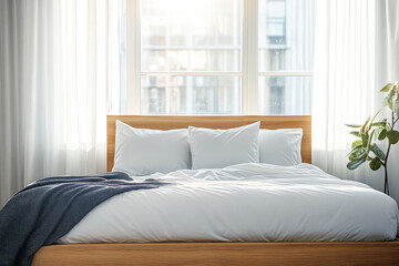 A bright, inviting bedroom featuring a cozy bed with white linens and large windows allowing natural light in during the morning