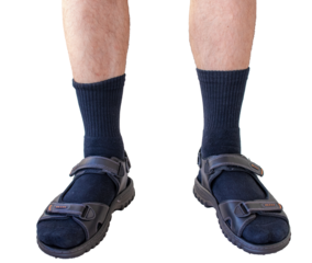 Man legs wearing black socks with sandals isolated.