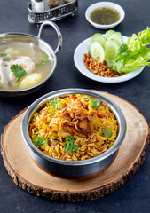 Chicken biryani in Bowl served on a table