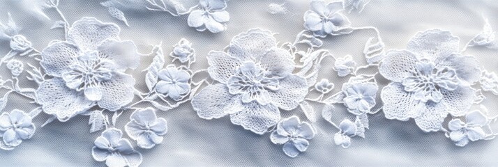 Intricate lace fabric texture in delicate white, creating floral patterns