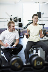 Personal trainer, clipboard and people with workout in gym for weightlifting, coaching and notes. Woman, fitness and man with checklist in session for training, help and tracking progress in exercise