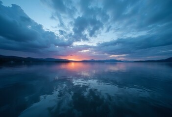 Obraz premium Lakeside at Dawn with Golden Sky and Silhouetted Mountains