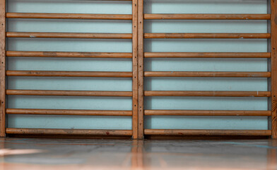 Wooden wall bars for gym exercises mounted on light blue wall offering sturdy structure for physical activities and training