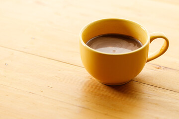 Cup of delicious hot chocolate on wooden table background. Copy space. Selective focus.