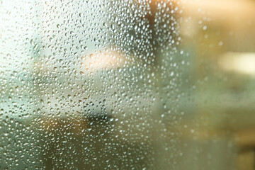 Rain drops on window glass. Rainy season. Selective focus.