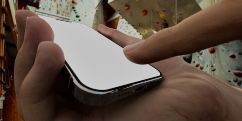 Caucasian White male using smartphone with a blank white screen. Climbing, gym, indoor apps mockup. Vertical phone orientation