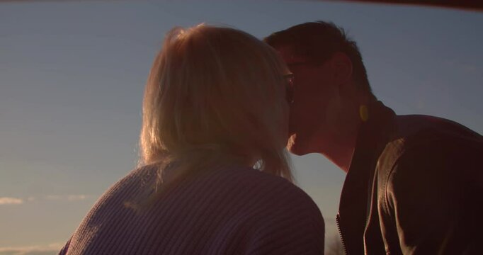 Young couple kissing in romance at sunset, Love happiness and care for person you are dating with committed and loyal relationship intention