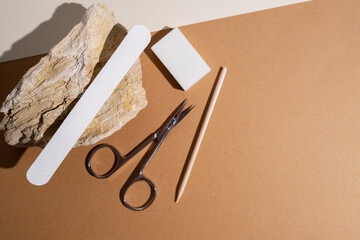 Manicure and pedicure tools composition, flat lay. Nail polish, file, scissors. Professional nail...