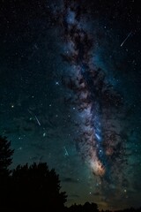 Majestic starry sky above a house in a field.