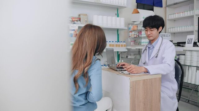 Asian female patient have symptoms backache and muscle inflammation to consulting doctor at clinic. Asia customer woman want to buying medicine backache relief with pharmacist man at pharmacy shop.