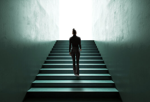 Silhouette of a Woman Climbing Stairs Towards Light, Symbolizing Career Growth and Success.