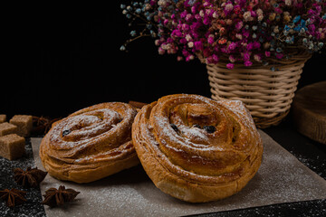 Fresh baked goods on a black background. Sweet buns