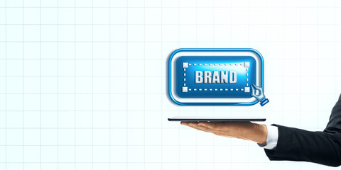 Digital branding concept represented by a tablet with a 'brand' icon on a light grid background.