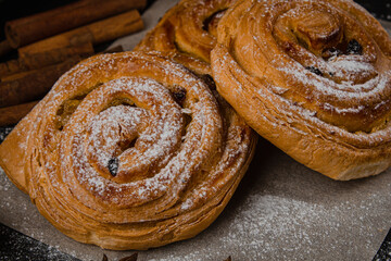 Fresh baked goods on a black background. Sweet buns