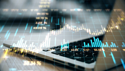 Double exposure image of laptop keyboard overlaid with financial graphs and charts on virtual background.