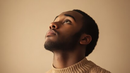 Fototapeta premium Man Gazing Up with Quiet Determination