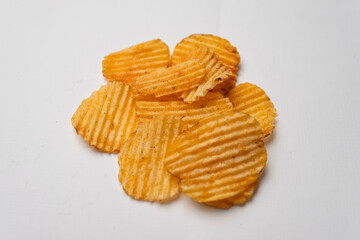 A pile of potato chips sitting on a white background