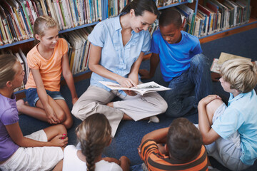 Teacher, group and children for education in library with book discussion, creative reading and...