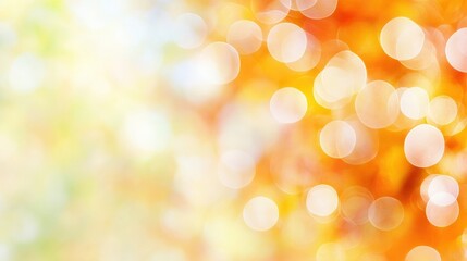 Obraz premium A soft, abstract background featuring warm orange and yellow bokeh lights, creating a vibrant, dreamy atmosphere.