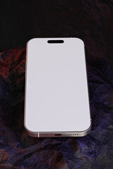 mobile phone with blank screen sitting on the rock use for mockup phone