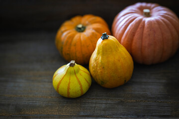 Autumn or halloween background - Orange and yellow pumpkin on a rustic wooden background 