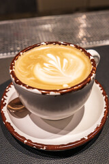 Coffee cup with latte art in coffee shop