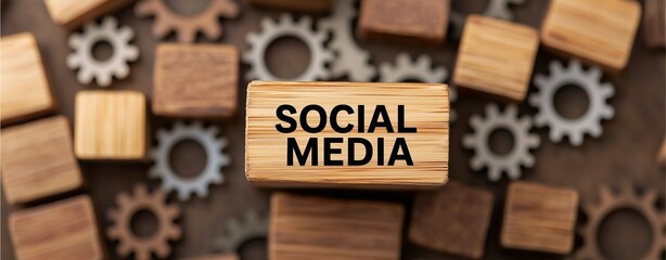 Wooden block labeled SOCIAL MEDIA surrounded by cubes and wooden gears.