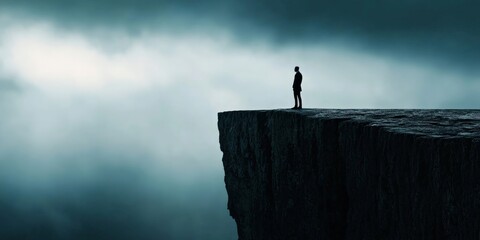 A person standing at the edge of a cliff, with a storm brewing behind them, representing the overwhelming nature of work stress.