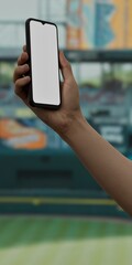 Caucasian White male using smartphone with a blank white screen. Stadium, baseball, diamond apps mockup. Vertical phone orientation