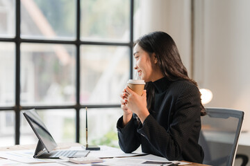 Coffee Break Inspiration:  A young businesswoman takes a moment of calm amidst the hustle and...