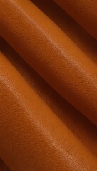 Close-up of orange leather fabric with smooth texture.