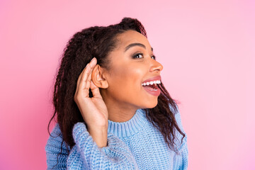 Photo of pretty young woman arm near ear listen eavesdrop wear pullover isolated on pink color...