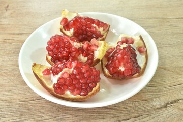 pomegranate tropical sweet red fruit half cut on plate