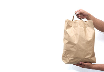 Man hand holding paper bag paper on a white background. Man hand with paper shopping bag. Close up...