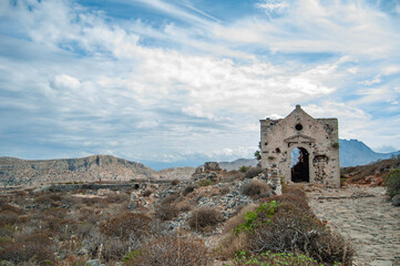 Ancient ruined stone abandoned building on top of a cliff. Summer Mediterranean landscape. Gramvousa, Crete island, Greece.