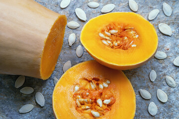 Pumpkin parts and pumpkin seeds on stone background