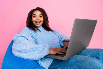 Photo of pretty young woman beanbag laptop wear pullover isolated on pink color background