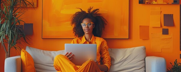 Entrepreneur working in a colorful, vibrant office surrounded by plants.