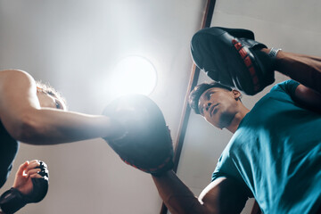 Fitness, boxing and woman in gym, training and practice with personal trainer, energy or exercise. Health club, sports and endurance of boxer, people or wellness of workout and coach in morning