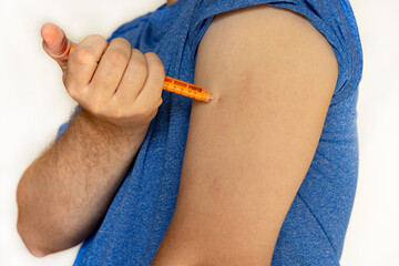 Senior man giving himself insulin injection at home, closeup. Insulin Injection Diabetes Drug Being Used For Weight Loss. Medical equipment for diabetes patient. Diabetes concept. insulin injection