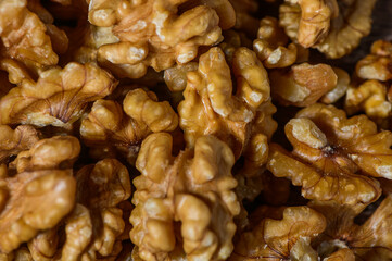 Many tasty walnuts as background, top view closeup of shelled organic walnut halves