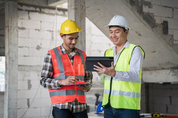 Civil engineer with personal safety equipment checking and consult with construction site foreman technician for inspect building construct process during follow up process. Engineering concept.