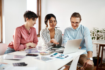 Creative, teamwork or designers on laptop in startup for planning, project review or meeting...