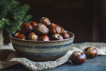 A bowl of shelled chestnuts sits on a table Lovely image of roasted chestnuts