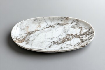 Aerial perspective of a flat oval marble dish on a gray background