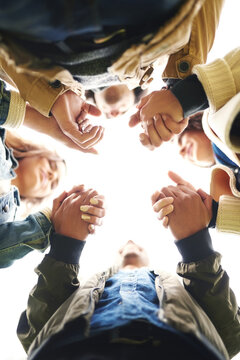 Support, circle and people holding hands together for prayer, solidarity or trust from below. Team building, connection and group of friends in huddle for worship, gratitude and care for community