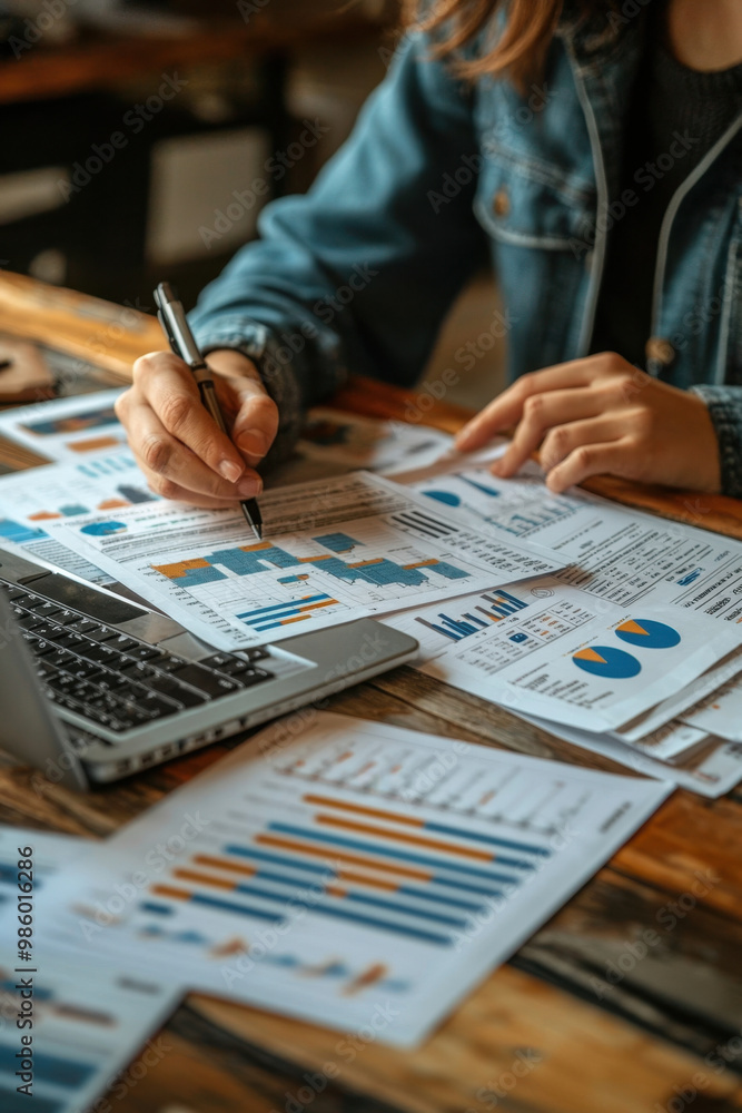 Poster business performance metrics, an individual examining printed reports of business performance metric